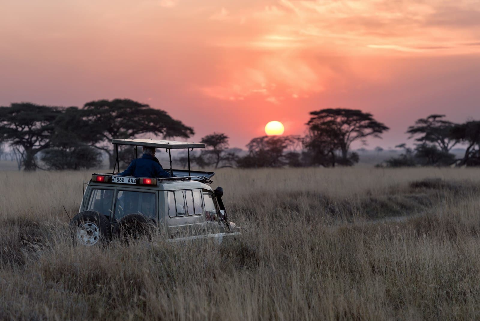 Safari vehicle at sunset in the Serengeti